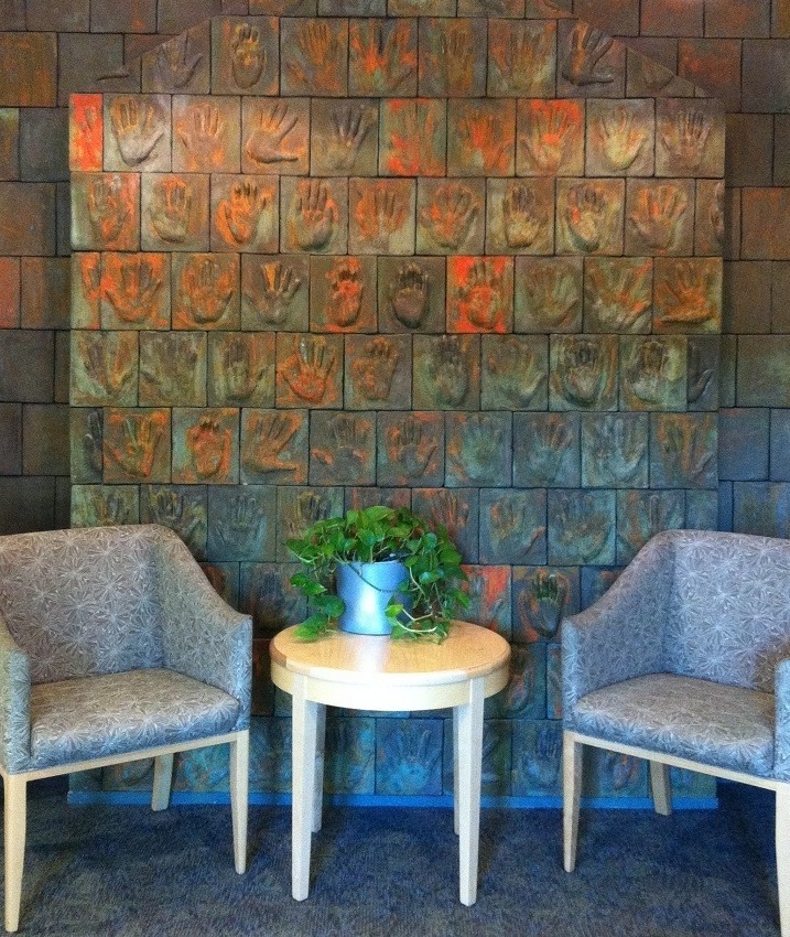 photo of wall of hands at HospiceAustin