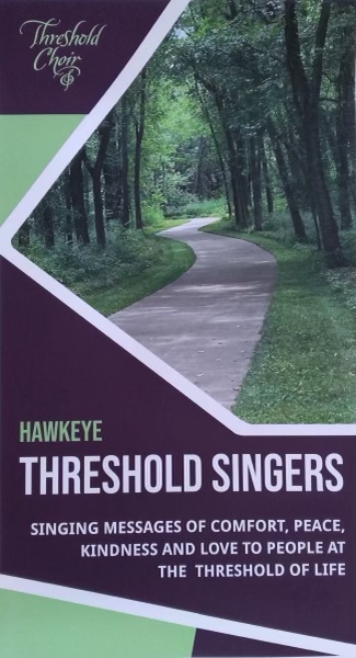Photo of path through the woods, overlaid by "Threshold Choir" and "Hawkeye Threshold Singers singing messages of comfort, peace, kindness and love to people at the threshold of life"
