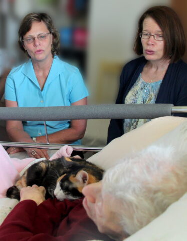 photo of singers at bedside
