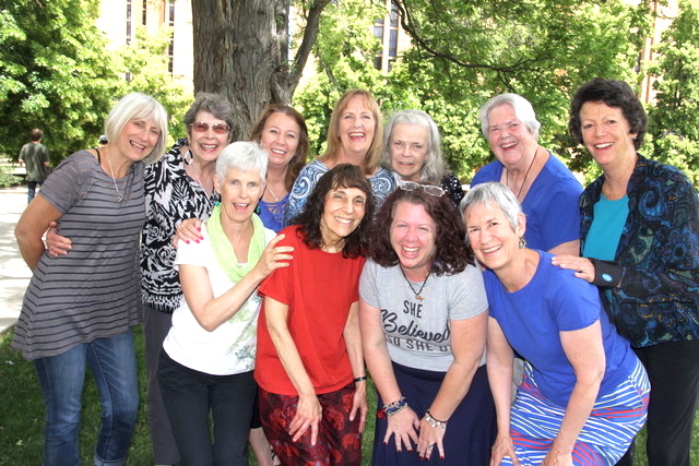 photo of 11 smiling women in front of trees