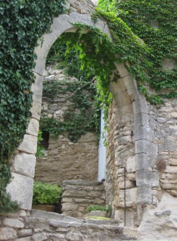 stone arch surrounded by greenery