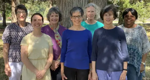 photo of 7 smiling women. Most are white.