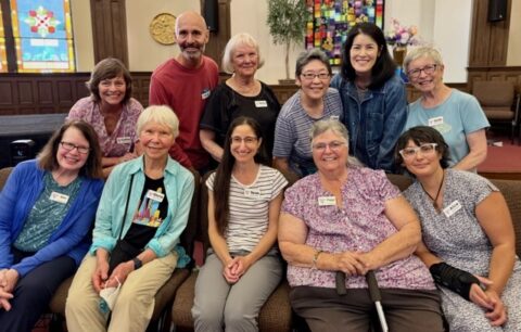 10 woman and a man, all smiling